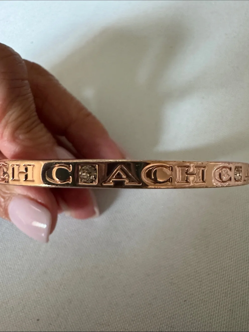 Coach Rose Gold-Tone Hinged Logo Bangle with Crystal Accents